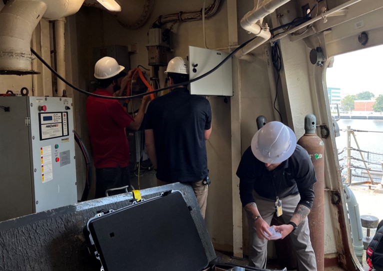 Three men working on ship